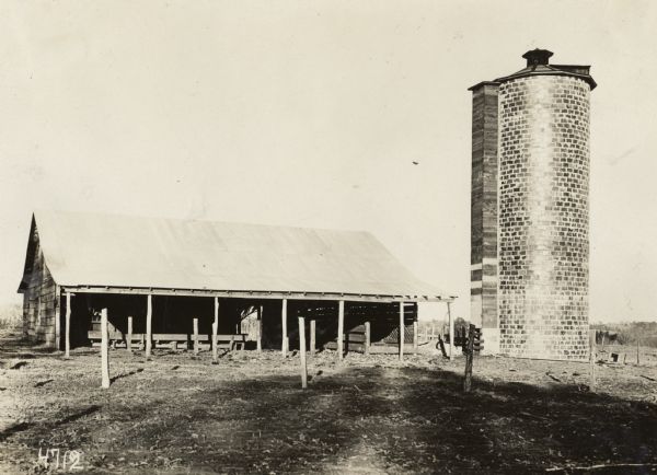 Livestock stable or shelter, and silo. Original caption reads: "85 ton silo on E.E. Temple Farm... The only silo in LaFayette Co. Mr. Temple raises considerable livestock but was not at home and stock was out so could not get them with silo."