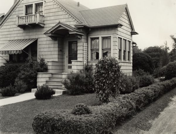Front yard landscaping of house in a residential neighborhood. Original caption reads: "Home of Mock Jr., 15 S. Commonwealth Ave., 2nd prize winner in 'Tribune' contest."