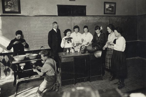 Group of agriculture students testing milk with teacher Gladys M. Smith at the Maplewood School.