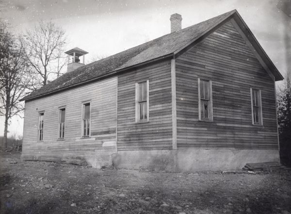 Exterior shot of Pleasant View schoolhouse. There is a bell tower on the roof.
