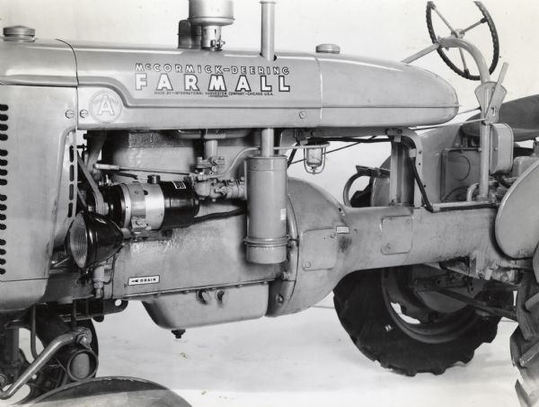 Side view of a Farmall A showing generator and decal placement.