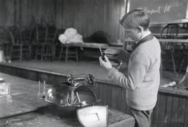 A boy at Mount Prospect High School testing corn as part of the Cook County School Home Project.