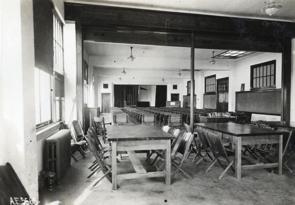 Interior view of tables and chairs lined in rows inside an auditorium at Orange Township Consolidated School.