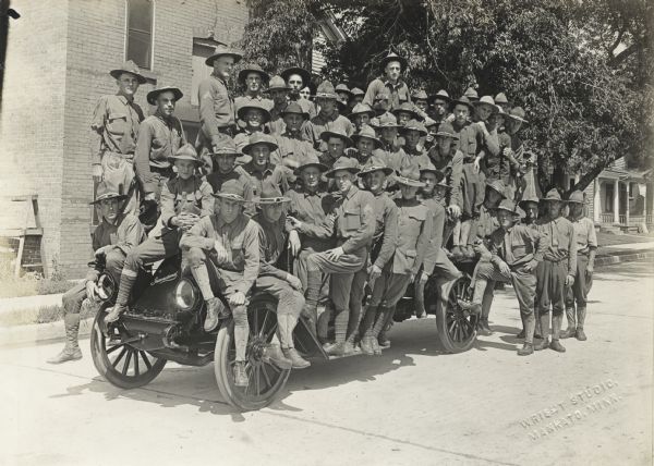 Large group of soldiers posing on an International Harvester Model F (or 31) truck.