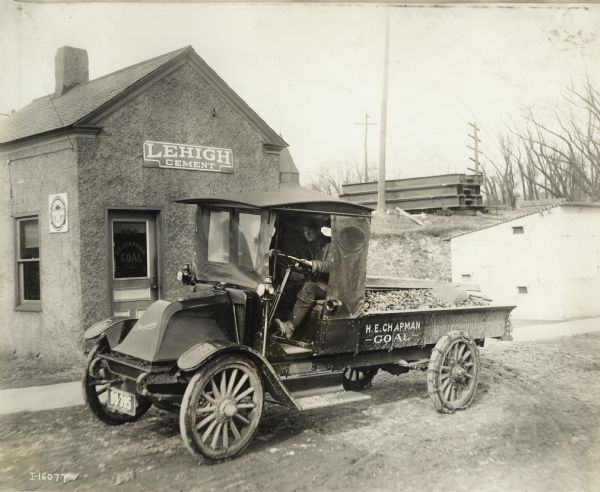 A man drives an International Model F (or 31) truck operated by H.E. Chapman Coal Company and Lehigh Cement.