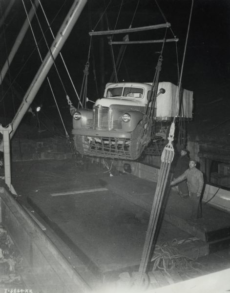 Original caption reads: "International motor trucks of Gatti-Hallicrafters Expedition being loaded into hold of S.S. "African Pilgrim" prior to voyage to Mombasa, British East Africa."