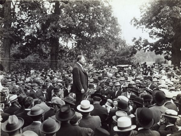 Governor Cox stands on a platform to address a crowd on the subject of alfalfa at the farm of Joe Wing.
