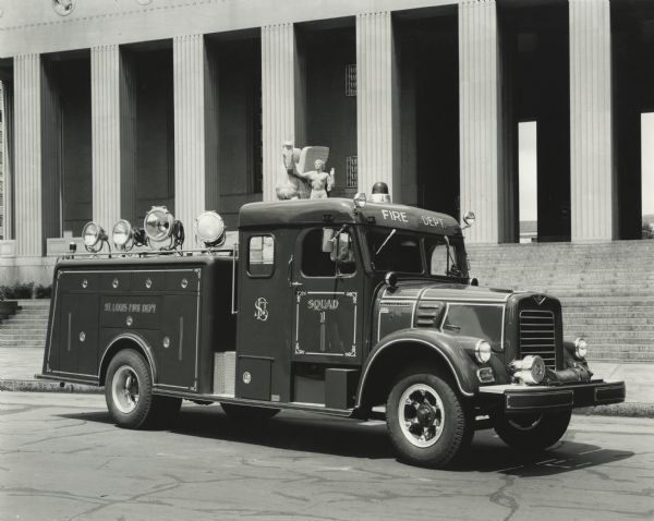 St. Louis fire company fire truck parked outside public building. Original caption reads: "V-196 A. 175" wheelbase. 9.00X20-10 ply tires dual rear, V-549 engine direct in fifth transmission. 6.5-1 axle ratio, 12 cu. foot compressor w/ fire department fast build-up. MU-7 Braden winch, Leese Nevile alternator 12 Volt, 100 amp. 110 volt 1200 watt DC power package. Gerstenlager squade rescue body and 6 men cab."