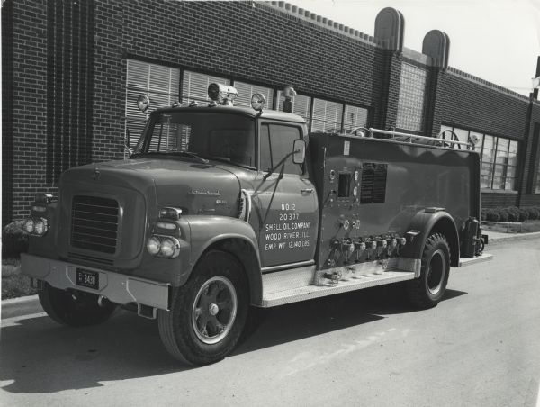 International Model B-170 1960 fire truck used by Shell Oil parked outdoors.