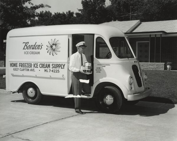 International Model S-120 truck used by Border's Ice Cream for deliveries. A delivery man stands near the passenger door of the truck holding some of the products. Text on the truck reads "Home Freezer Ice Cream Supply."