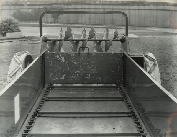 View of the inside of a McCormick-Deering manure spreader. Stenciled markings are on the inside of the back of the spreader. The markings show levels to help estimate tonnage per acre of manure. A factory decal is on the left side of the spreader. In later years these decals were moved to the outside to avoid being covered.