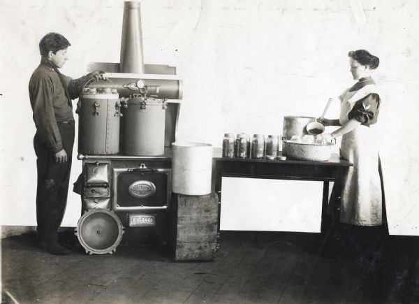 A brother and sister use an Eau Claire steam pressure machine to run their canning business.