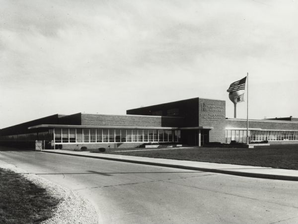 Exterior view of International Harvester's Motor Truck Engineering Department. Original caption reads, in part: "...The company also operates a 160,000 sq. foot Design Center in Fort Wayne; satellite operations in San Leandro, California, Springfield, Ohio, and Indianapolis, Indiana. Proving grounds in Fort Wayne and Phoenix, Arizona, complete the engineering complex, making IH's facilities the largest in the U.S. devoted exclusively to motor truck."