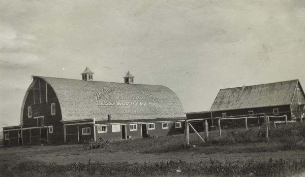 International Harvester Demonstration Farm located in Gull Lake, Saskatchewan, Canada. Text on the roof of the barn appears to read: "Vimy Ridge Stock Farm, Dealer in Cattle and Hogs".