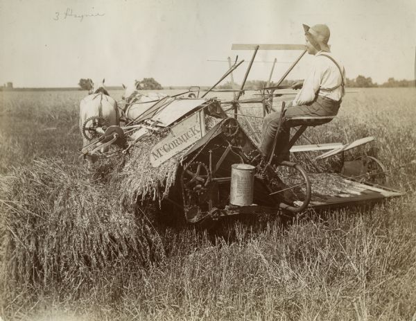 Man operating a horse-drawn McCormick grain binder in a field. Original caption reads: "Kinsella Grain Co., Colon, Nebraska. Aug 22/99. Gentlemen — In reply to your letter asking what I think of the McCormick Binder will say, that I don't have to do but little thinking, I run a McCormick Binder on my farm for ten years cutting on an average of 70 acres per year and did not pay out one cent for repairs; it is strong and durable, light draft and does the best work in down or tangled grain of any machine I ever saw work. Yours truly, Math Rasmussen."