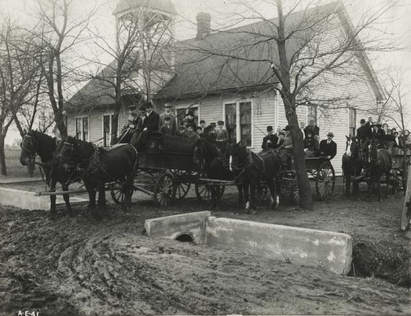 Farmers and Cook County students headed to a corn testing session in horse-drawn wagons. Original caption reads: "The farmers of this district were interested enough to bring their teams and haul the pupils to a 'bunch' house, a half-mile away, where the testing was done."