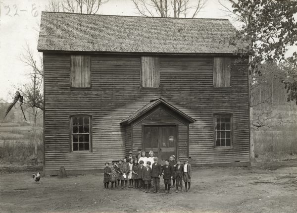 Class of students standing outside a rural school known as the Blackjack School.