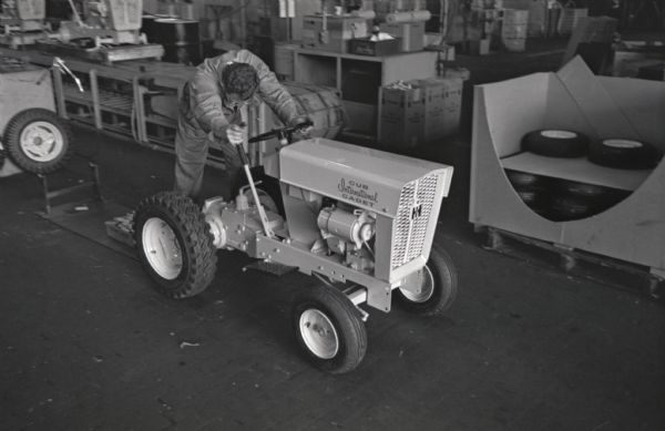 A factory worker with an International Cub Cadet lawn tractor at International Harvester's Louisville Works.