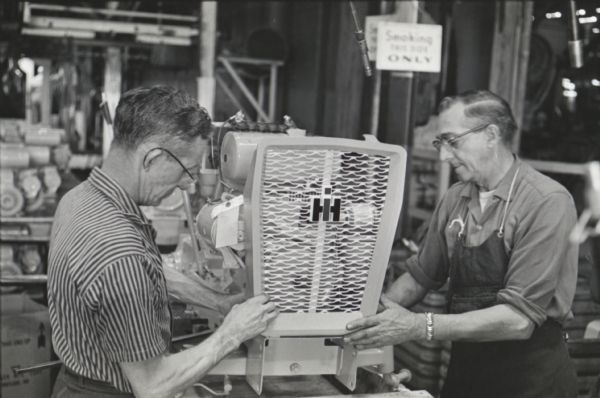 Factory workers place the front grille onto a Cub Cadet lawn tractor at International Harvester's Louisville Works.