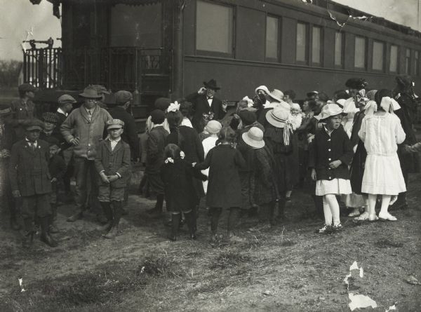 Group of youth gathered near a passenger car listening to a man identified as "Governor Howard." The man is most likely Edgar Howard, Lieutenant Governor of Nebraska. The train was part of the Union Pacific Farm Preparedness Special Campaign.