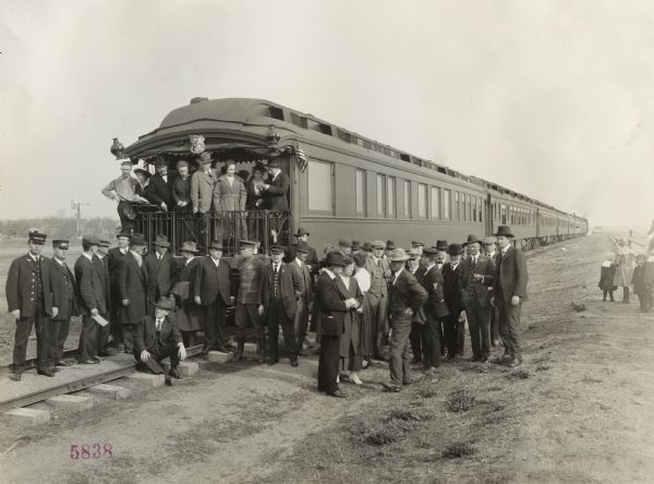 Group of men, with a few women and children, gathered around a passenger train on a stop of the Union Pacific Nebraska Preparedness Special Campaign.