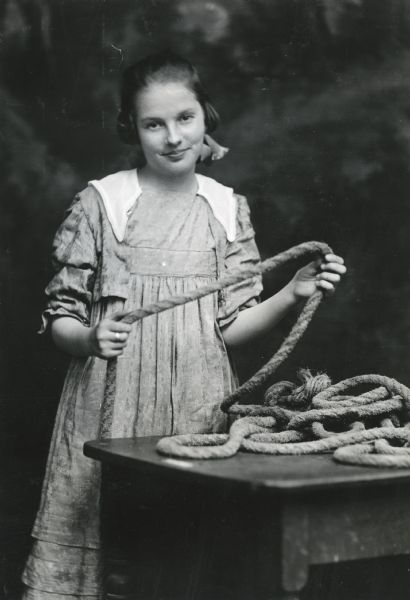 Cleo Holt posing for a portrait while holding a rope.