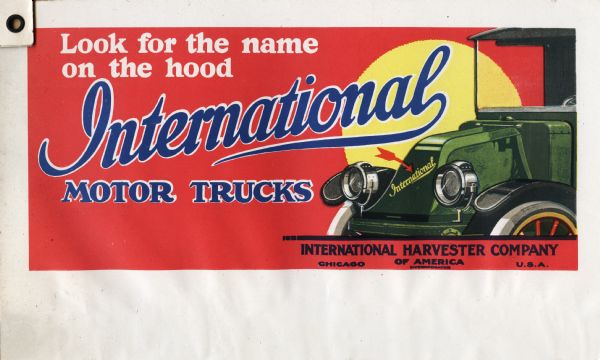 Billboard design for International motor trucks featuring an illustration of the front wheels, hood and cab of a green truck against a red background. The text on the billboard reads: "Look for the name on the hood. International Motor Trucks. International Harvester Company of American (Incorporated) Chicago U.S.A."