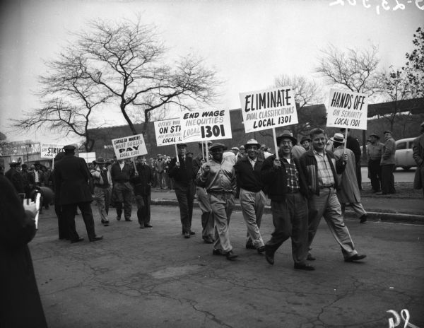 International Harvester factory workers hold signs as they picket while participating in a "steel strike" near Tractor Works.
