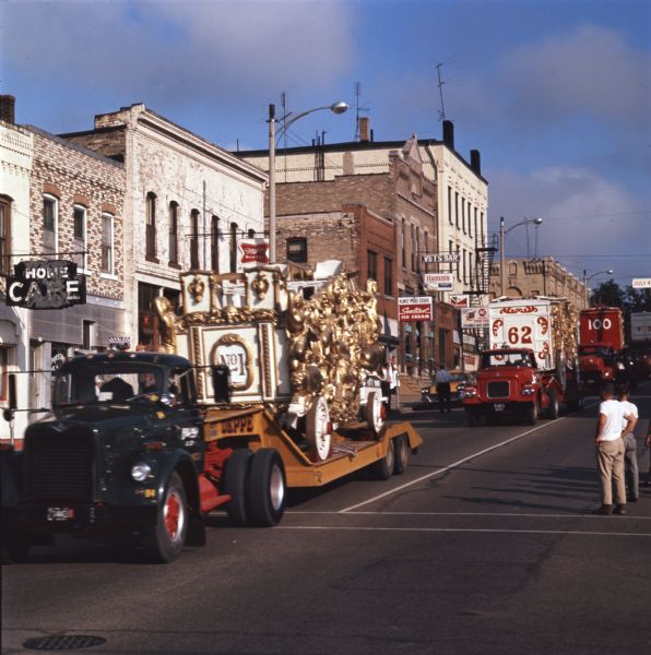 A restored 19th century circus wagon travels down a commercial road on a trailer during a parade. The 25-piece circus parade traveled from Circus World Museum in Baraboo to Milwaukee.

