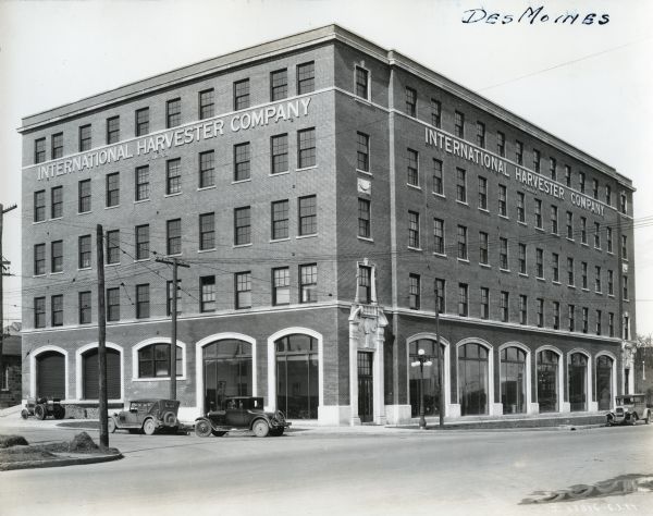 Exterior view of International Harvester's Des Moines branch building.  The structure features five stories and arched ceiling-height windows surround the ground floor.