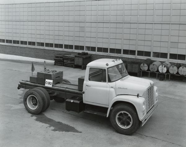 Elevated view of an International Loadstar truck parked in front of a factory building.