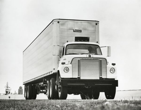 Ground level view of an International Fleetstar semi-truck outfitted with a Fruehauf trailer. The truck may be a model 2010-A.