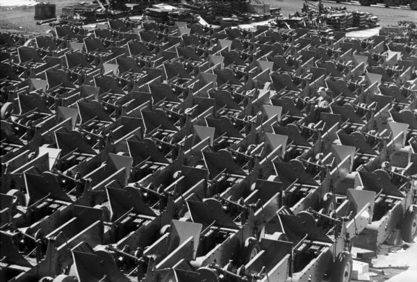 Elevated view of balers arranged in rows outdoors in a factory yard at International Harvester's Memphis Works.