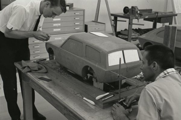Two aspiring industrial designers work to create a clay model of a "Multipurpose Safety Utility Vehicle" during the first styling seminar at the Fort Wayne motor truck engineering department. The program lasted ten weeks and participants were college students in their junior year.