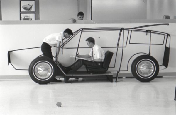 Jack Willer (left) stands in front of John Hutton (seated) to discuss the design of a "Multipurpose Safety Utility Vehicle" at International Harvester's first styling seminar at the Fort Wayne motor truck engineering department. Darold Cummings looks on from above. The program lasted ten weeks and participants were college students in their junior year.