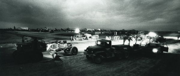 Men from the Air Force's Red Horse heavy repair squadrons use International equipment to clear land in Vietnam, possibly for construction of barracks or a runway.