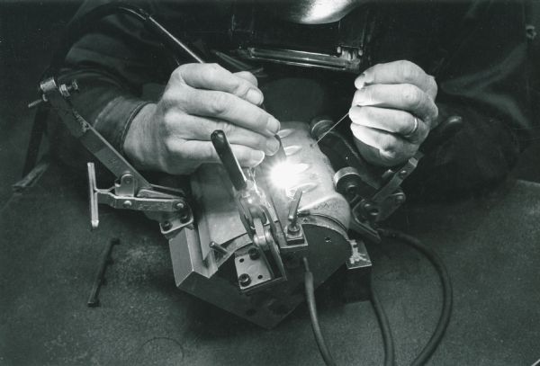A man works on a component of the boundary layer control system, used to reign in the Phantom II jet's horsepower for landing at slow speeds.