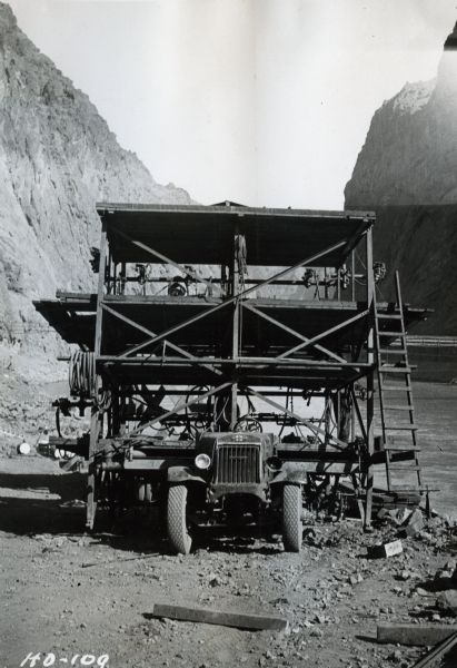 Front view of a three-deck drilling platform mounted on an International truck. The device was used in the interior of the tunnels during construction of the Hoover Dam.