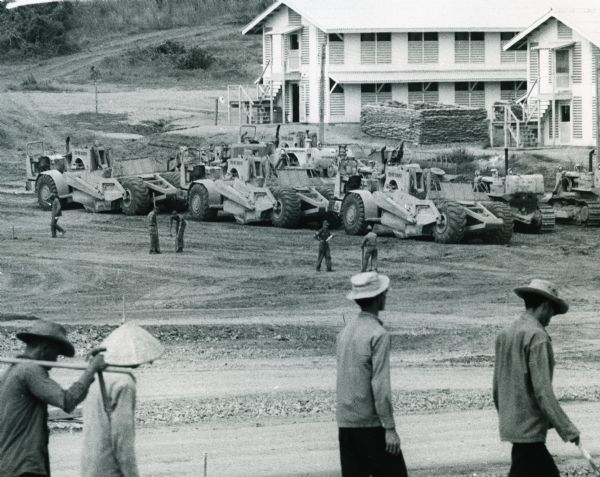 Men from the Air Force's Red Horse squadron, a civil engineering support force, use International Harvester construction equipment to make way for a runway at the South Vietnam Air Force base of Phan Rang.