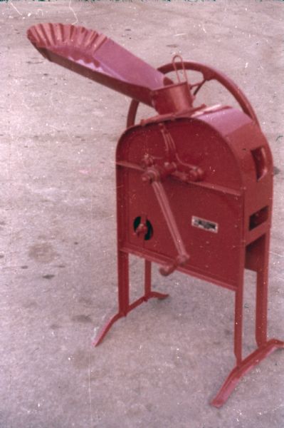 Color photograph of a one-hoe all steel corn sheller made at Saltillo Works, an International Harvester factory in Mexico.