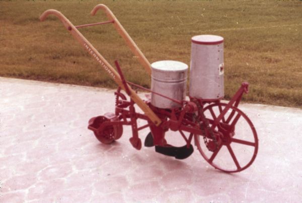 Color photograph of an International horse-drawn walking corn planter made at Saltillo Works, an International Harvester factory in Mexico.