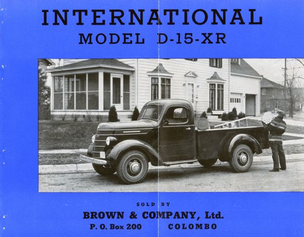 Advertising brochure for the International D-15-XR truck featuring an illustration of a man unloading a truck on a residential street. This particular catalog was printed for Brown & Company, Ltd. P.O. Box 200 Colombo.