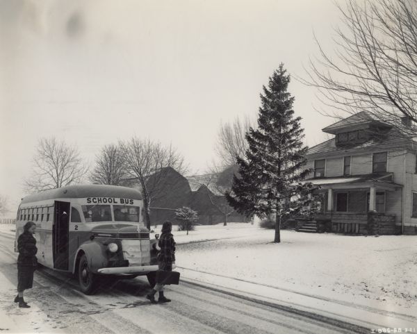 International D-40 bus dropping school children off in a residential neighborhood on a snowy day. The bus was equipped with a 235-inch Rex-Watson 49 passenger body.