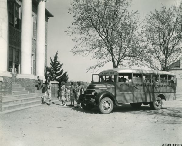 International D-30 bus dropping students off at Wendell Graded School. This bus was equipped with a 155-inch wheel base and a Hackney body.