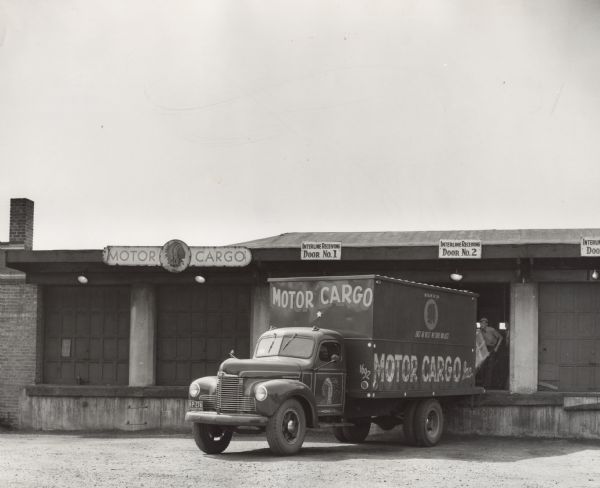 International KB-5 truck unloading at loading dock. Original caption reads: "An International KB-5 with 76-inch wheelbase owned by Motor Cargo Incorporated of Chicago, Illinois."