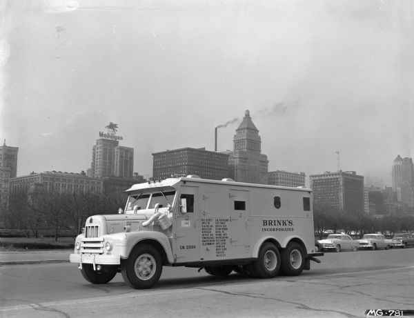 International RD-190 (?) truck with an armored body, operated by the Brinks Express Company on Lake Shore Drive. Automobiles are in the background. In the far distance is the Mobil Gas building.