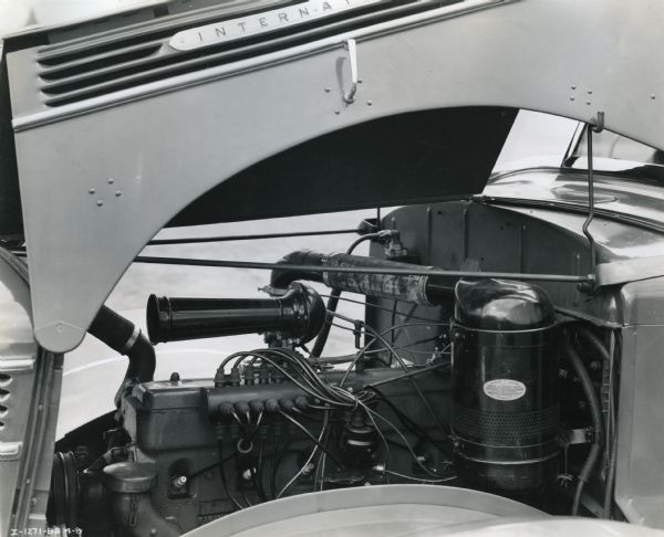 The hood is lifted on an International D-50 fire truck to reveal the engine.