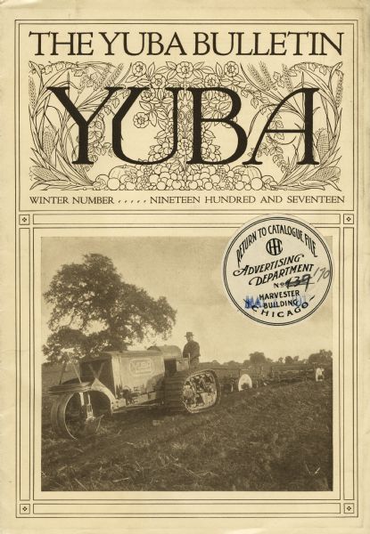 Front cover of the winter edition of the "Yuba Bulletin," a publication produced by the Yuba Products Company to advertise their line of agricultural merchandise. The cover features a photograph of a man using a Yuba tractor in a farm field. The tractor is a half-track crawler.