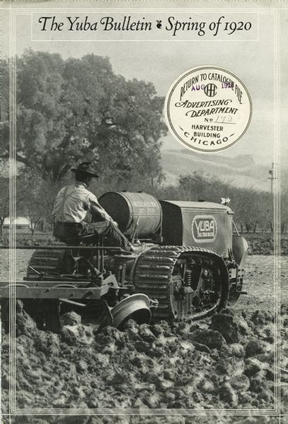 Front cover of the "Yuba Bulletin" spring edition, a publication produced by the Yuba Products Company to advertise their line of agricultural machinery and equipment. The cover features a photograph of a man using a Yuba ball tread tractor to work in a farm field. The tractor is a half-track crawler.