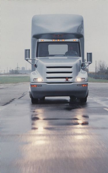Front view of an International IDEA truck as it is driven down a street wet with rain. IDEA was an acronym for International Design and Engineering Assessment.